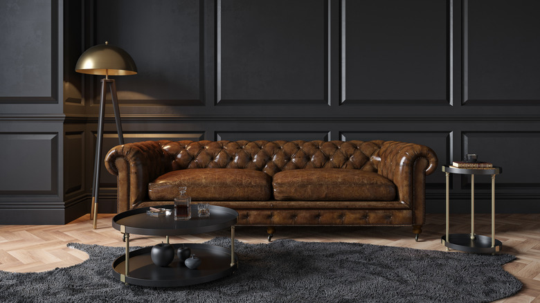 Leather sofa in a living room with black walls