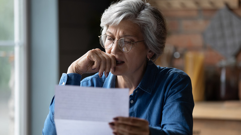A person sitting at a desk evaluating a document.