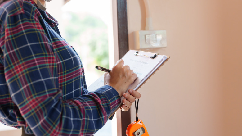 A person holding a clipboard.