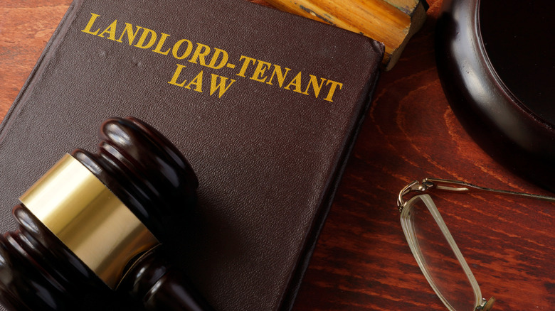A landlord-tenant law book on a desk.