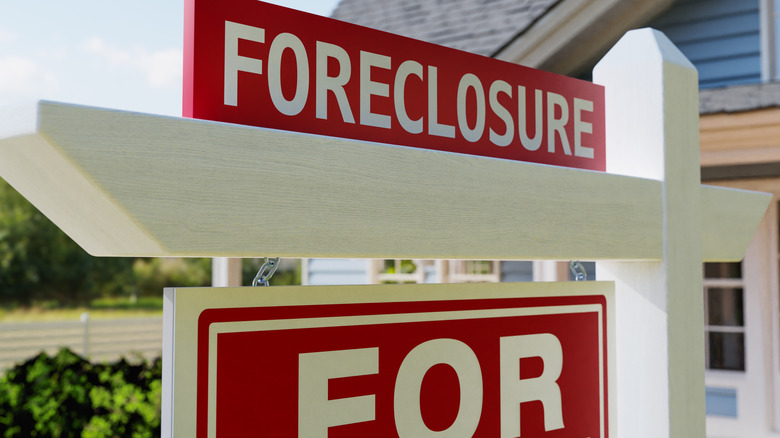 A home with a foreclosure sign in the yard.