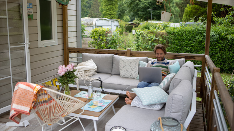 Man working outside on comfortable outdoor seating