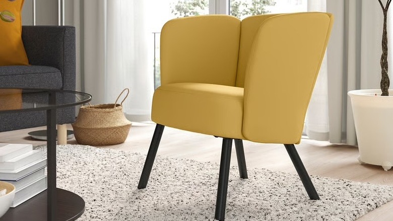 A bright yellow accent chair in a modern living room.