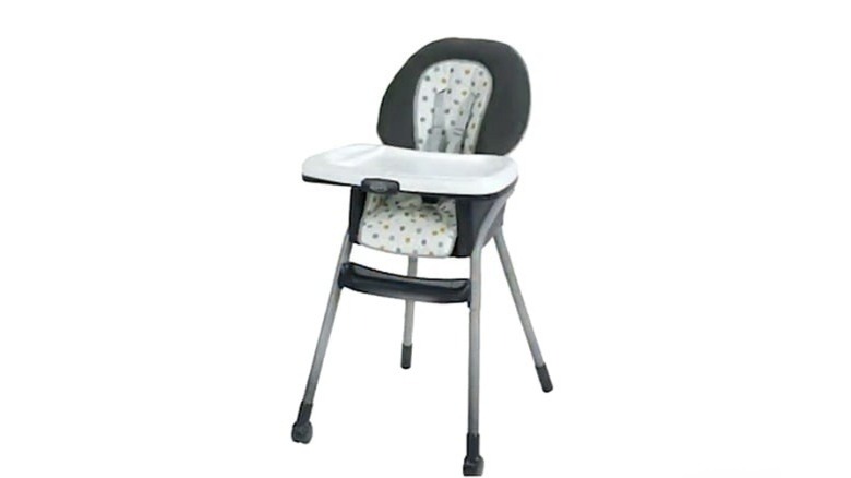 A white and gray Graco Harmony high chair