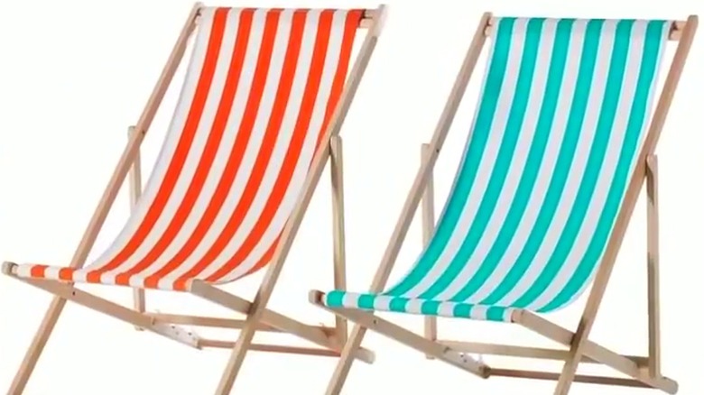 Two IKEA MYSINGSÖ beach chairs in orange-and-white and blue-and-white stripes