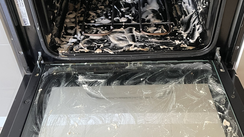 An oven door and oven interior is coated with a baking soda paste mixture