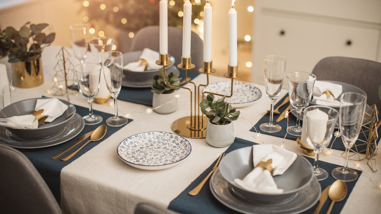 Blue table setting gold utensils