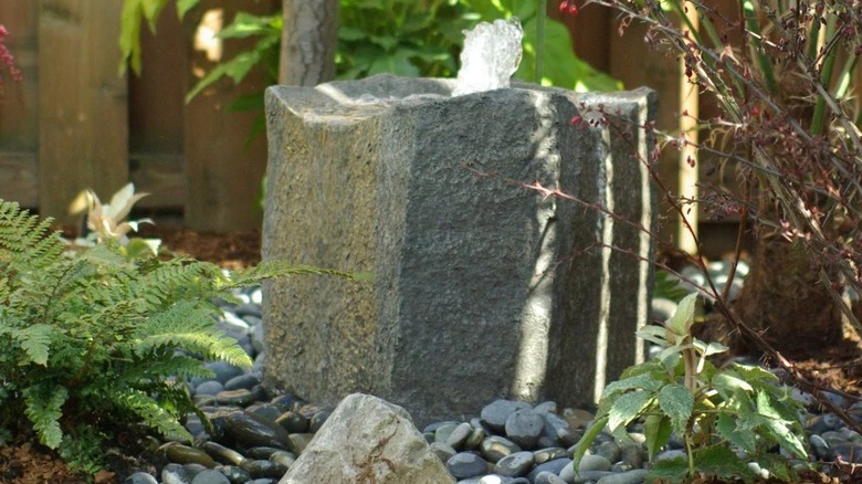 A stone-like fountain amidst natural elements