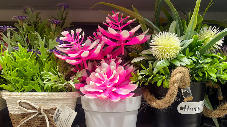 Artificial flowers with pots on sale in a store