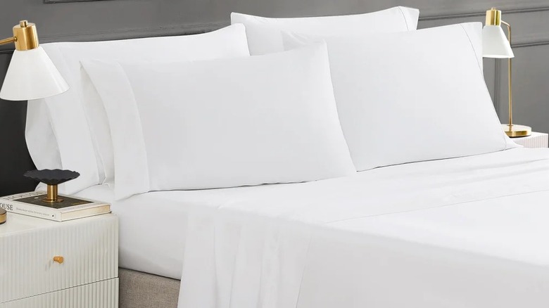 White bedsheet and pillows on a bed in a room