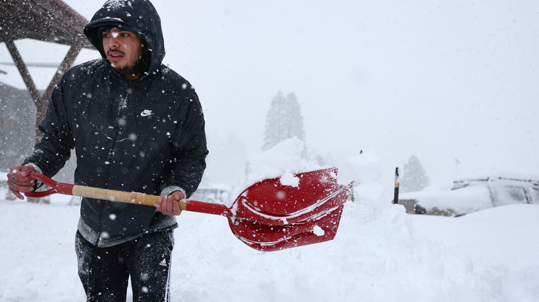 Man shoveling snow in snow storm