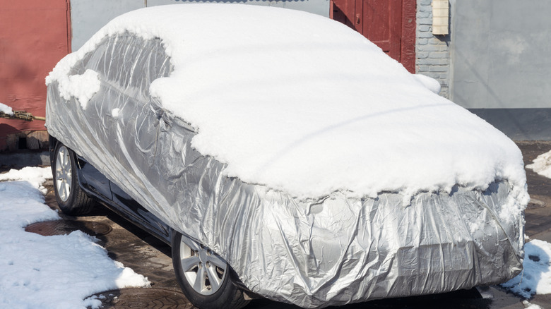 Car cover covered in snow