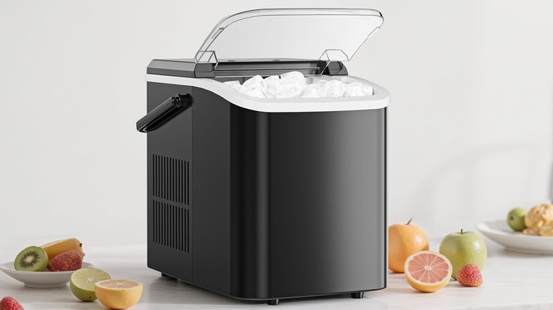 A black ice maker filled with ice on a countertop