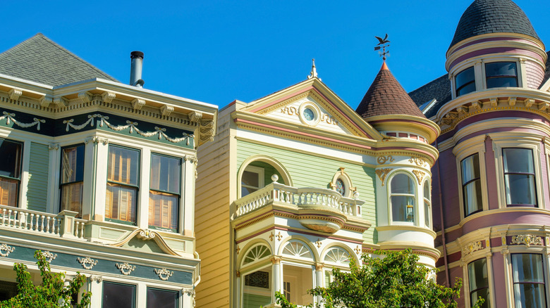 A group of Victorian homes in different colors
