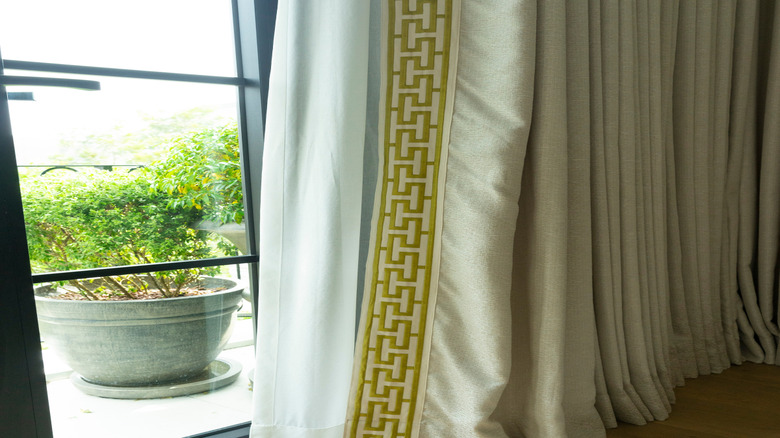Gold key pattern trim on a beige curtain