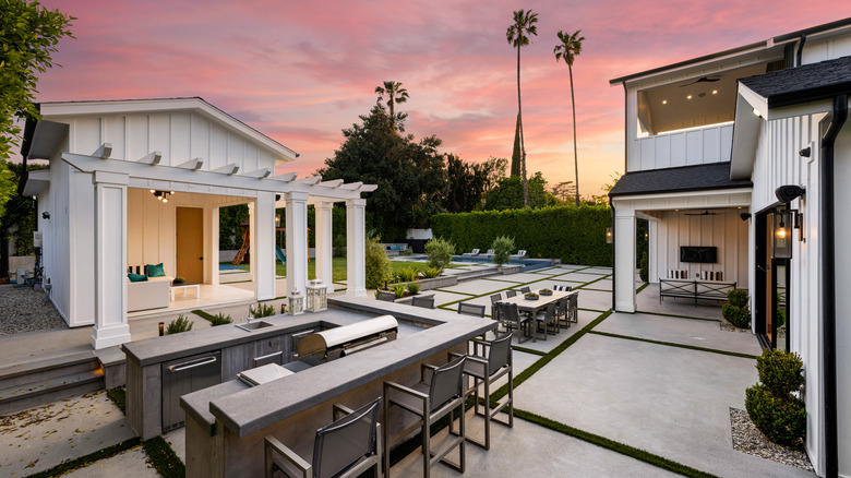 A large outdoor kitchen in a backyard