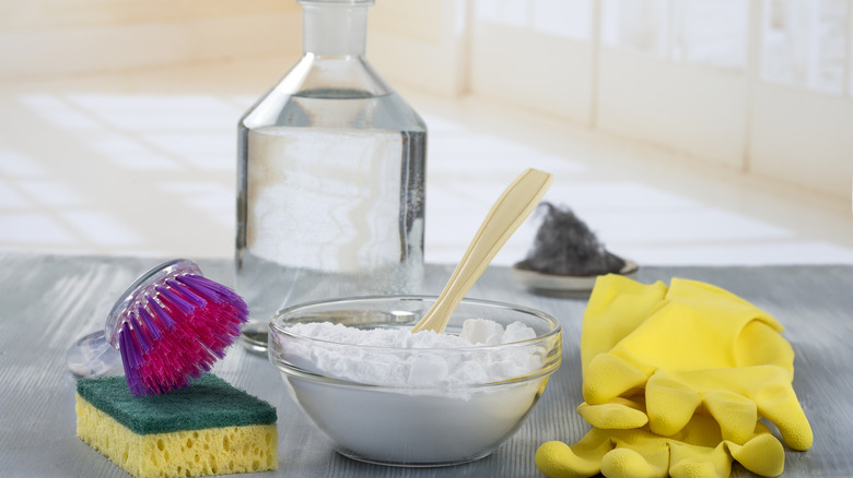 bowl with baking soda next to cleaning supplies