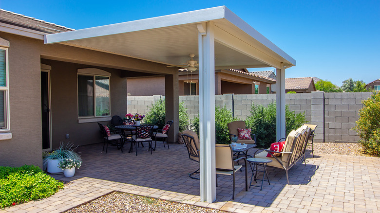 A brick patio with a pergola attached to a single-story house