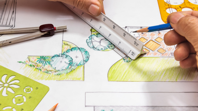 Close-up of a landscape architect drawing plans for a garden and patio