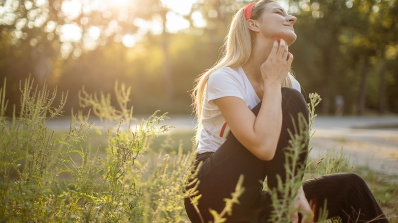 Woman with allergic reaction to nearby ragweed
