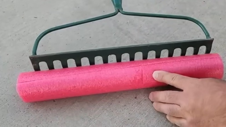 Pool noodle cut to fit over the tines of a rake