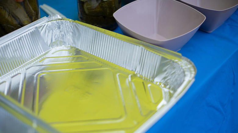 Aluminum baking dish with food inside.