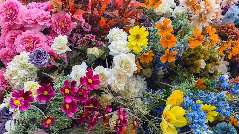 An assortment of artificial flowers in different colors and species.