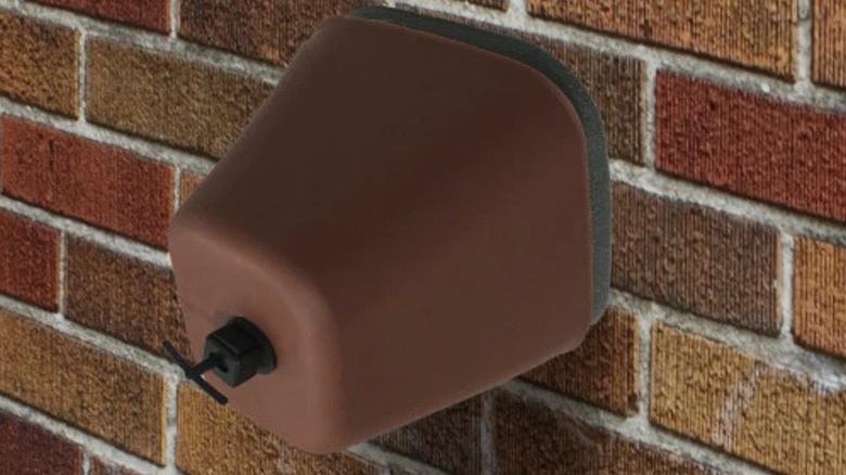 Frost King FC2 Plastic Faucet Cover on exterior brick wall