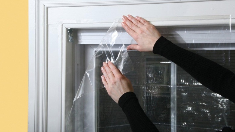 Frost King V76H Shrink Window Kit being installed on inside of window