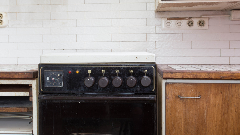 An old oven in an aged-looking kitchen