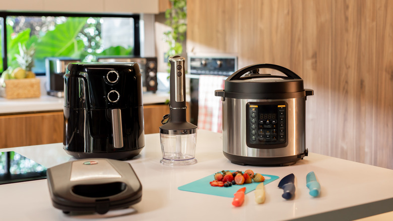 A kitchen counter with a selection of electrical appliances