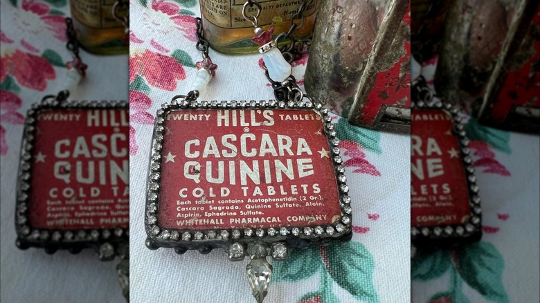 red vintage medicine tin with jewels on it