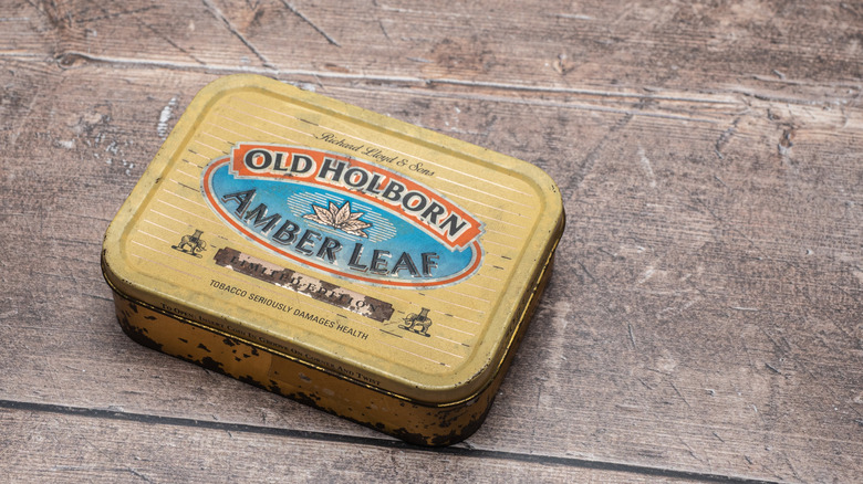 yellow Old Holborn tobacco tin on wood table
