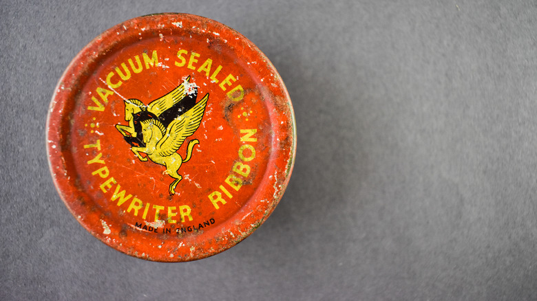 red and yellow vintage typewriter ribbon tin
