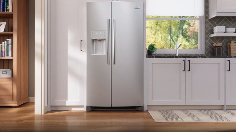 A stainless steel fridge in a white kitchen