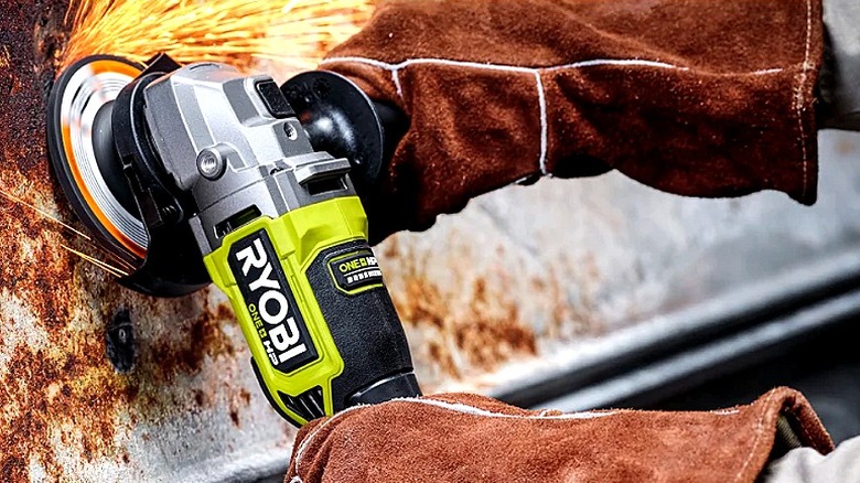 Someone using an angle grinder while wearing protective gear