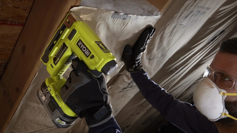 Person using a Ryobi crown stapler
