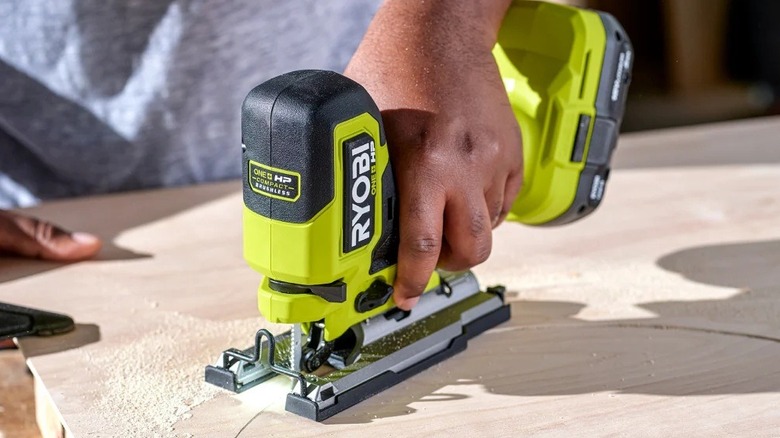 Person using a Ryobi jigsaw