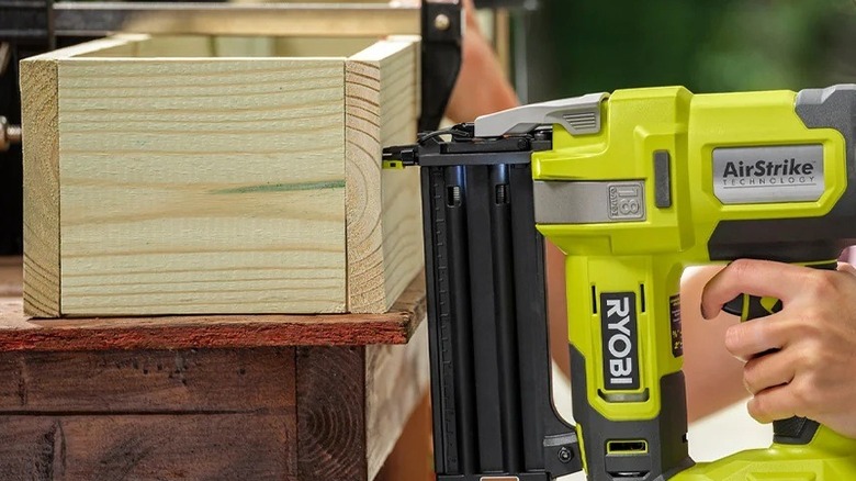 Person using a Ryobi brad nailer