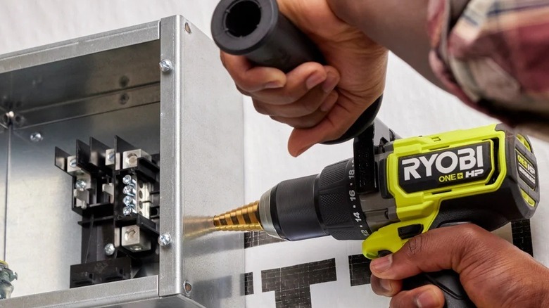 Person using a Ryobi hammer drill