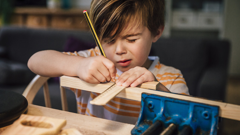 Little boy working on a building project