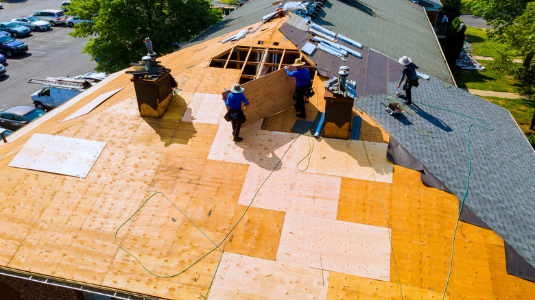Aerial view of workers replacing a roof