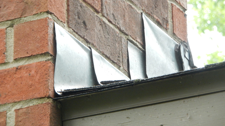 Metal flashing on the side of a brick chimney