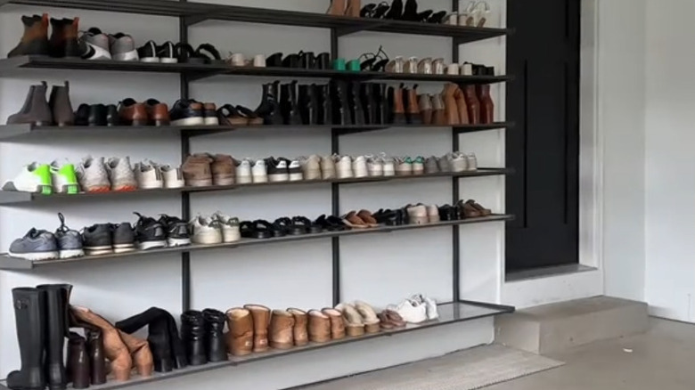Wire shelves in the garage with shoes on them