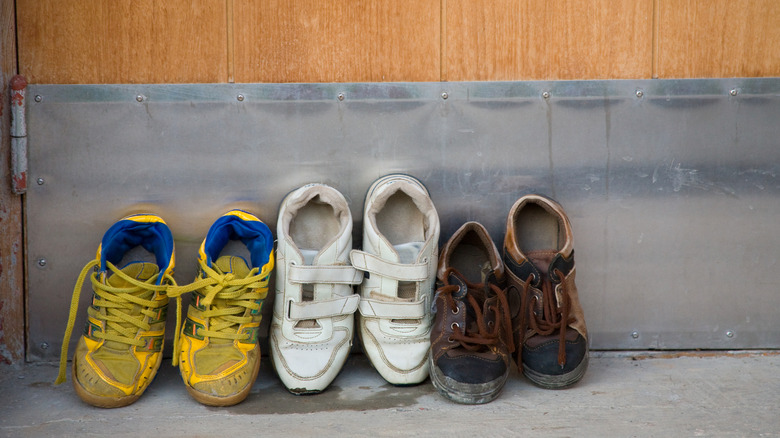 Shoes lined up on the garage floor