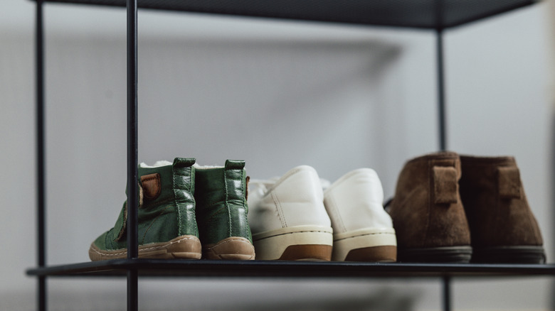 Metal shoe rack with a few clean pairs of shoes