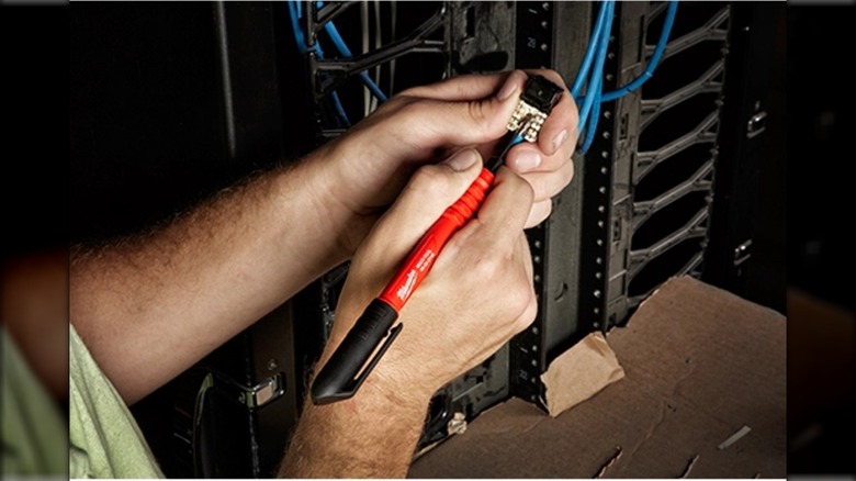 A person performing electrical work with Milwaukee's 4-in-1 Multi Pick