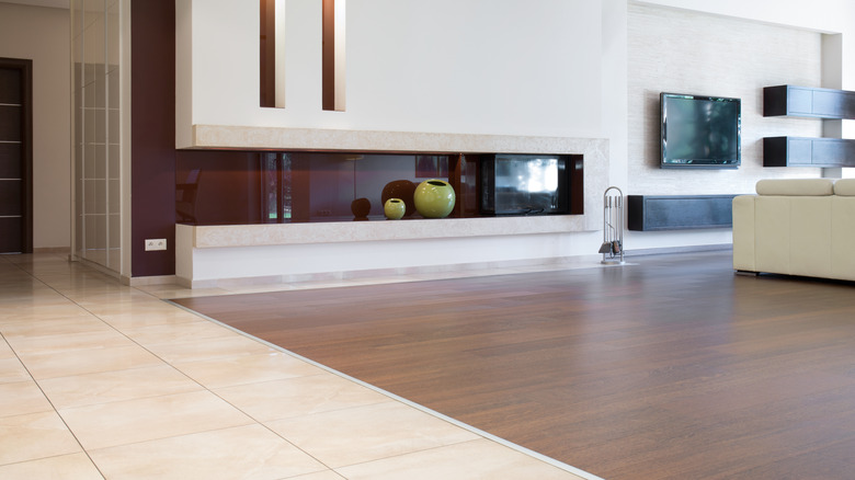 Open floor plan with wood floor living room and tile floor entry