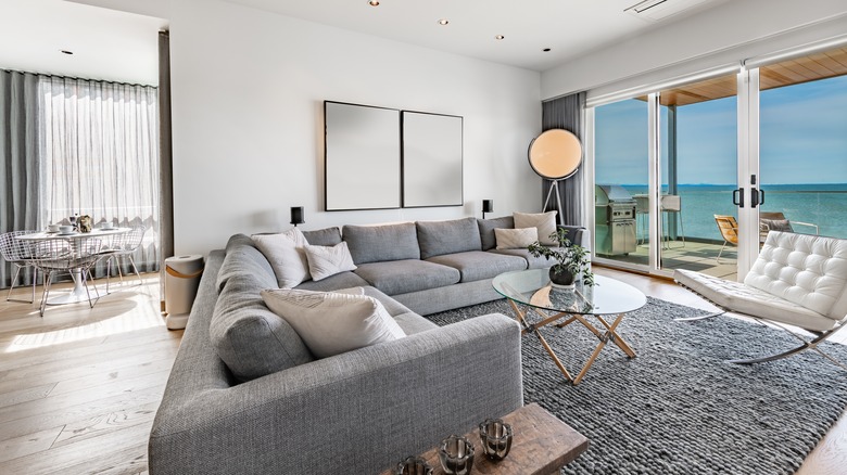 A couch being used to section off living room