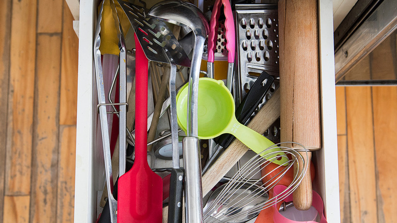 A cluttered kitchen drawer
